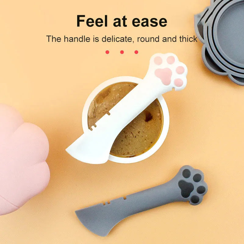 Multifunction silicone pet food spoon and can opener with pink lid, 5.1 inches long, paw-shaped scoop, white background