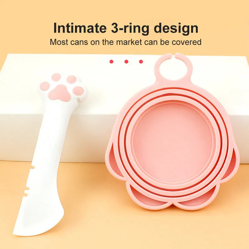 Multifunction silicone pet food spoon and can opener with pink lid, 5.1 inches long, paw-shaped scoop, white background