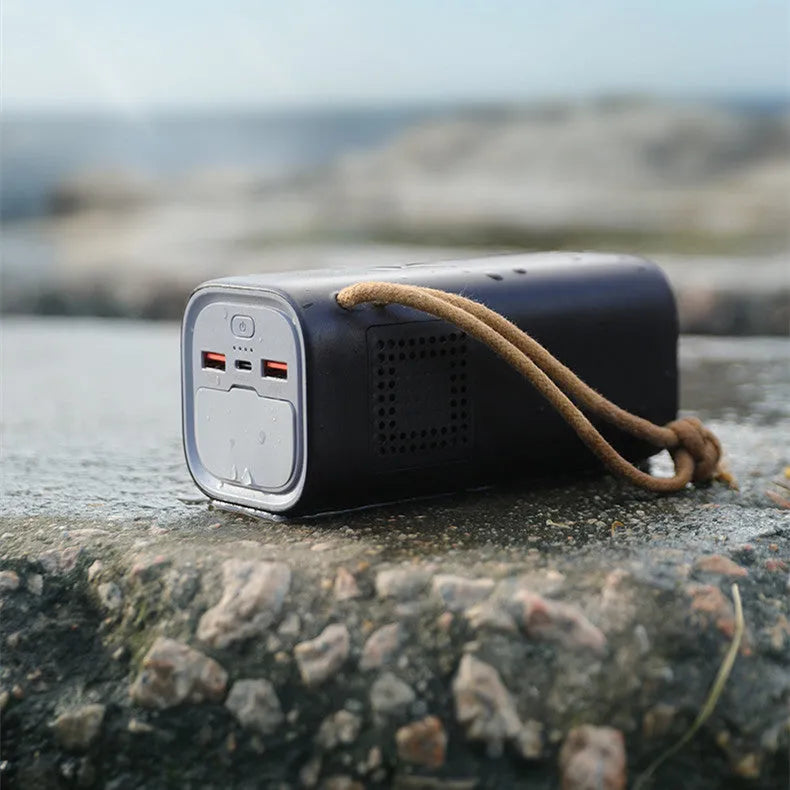 Black portable power bank with 20000mAh capacity, 220V output, and solar panel input for outdoor charging.