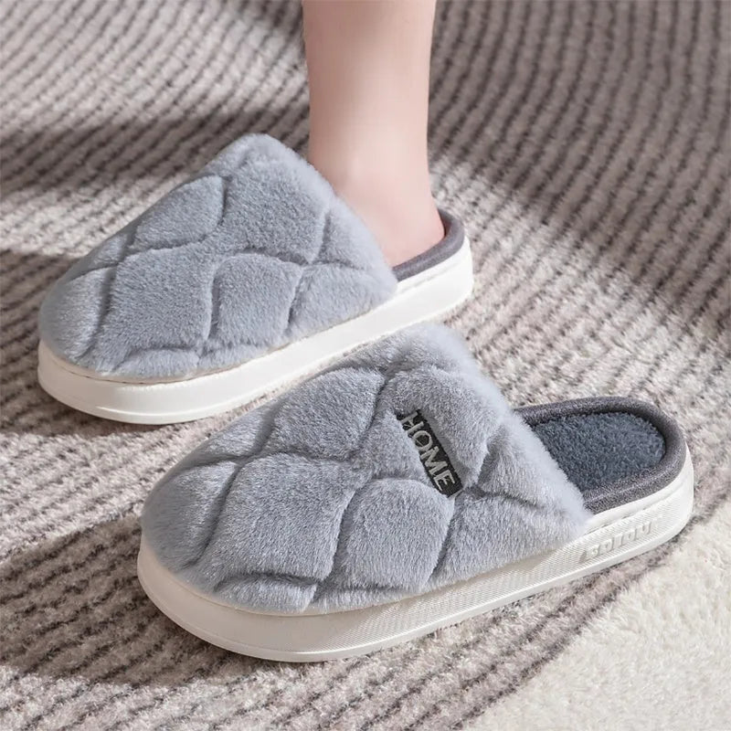 Plush indoor slippers in light gray with car stitching detail on the upper and PVC sole
