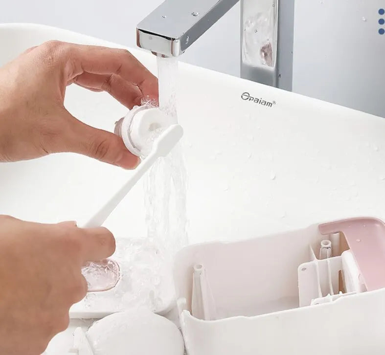 Automatic wall-mounted toothpaste dispenser in blue colour on a bathroom wall.
