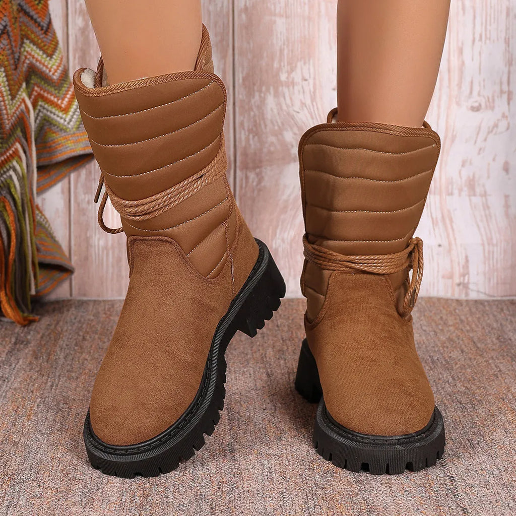 Women's chunky heel mid-calf snow boot with lace-up front and fleece lining in black, brown, or grey.