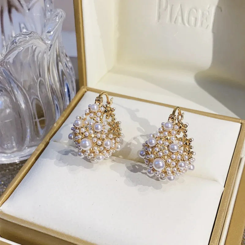 Gold colour women's floral basket design earrings with small beads and pearl inlay on copper
