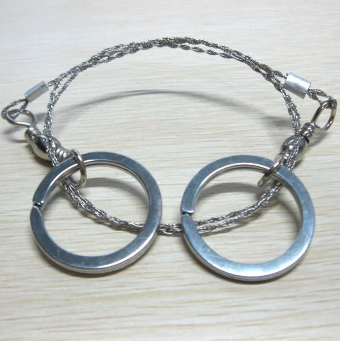 Stainless steel wire survival saw with thumb rings coiled for outdoor camping