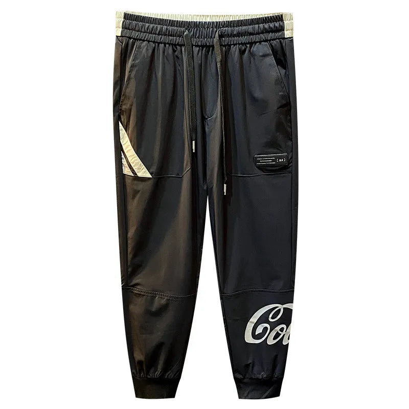 Men's solid black cropped trousers with banded ankles made from ultra-thin ice silk and cotton blend fabric.
