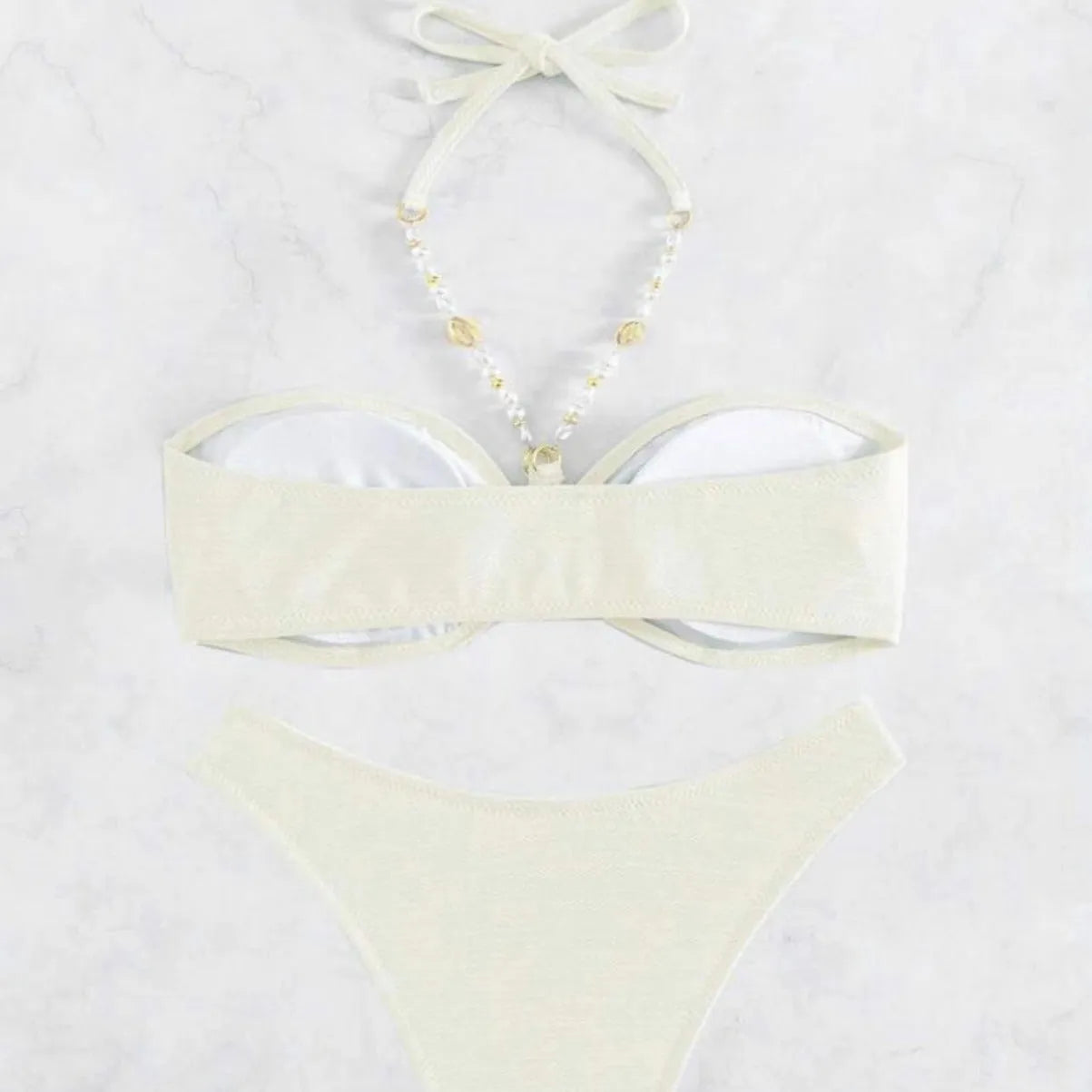 Women's solid colour halter bikini set in creamy-white, shown front-on.