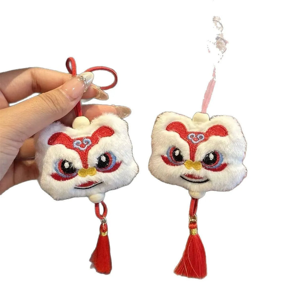 Chinese style plush lion keychain ornament with cartoon design and star stone details on blue background