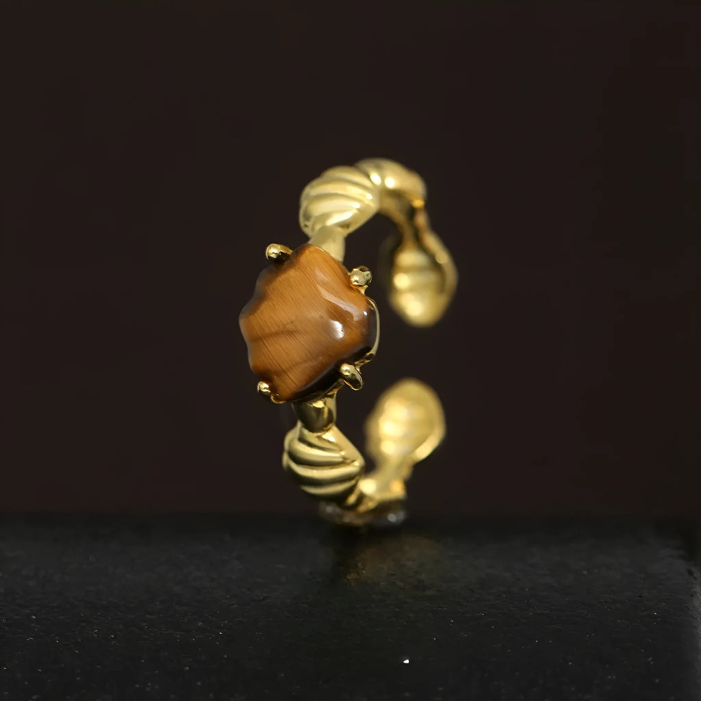 Women's adjustable silver ring with a shell tiger eye design in a gold tone finish.