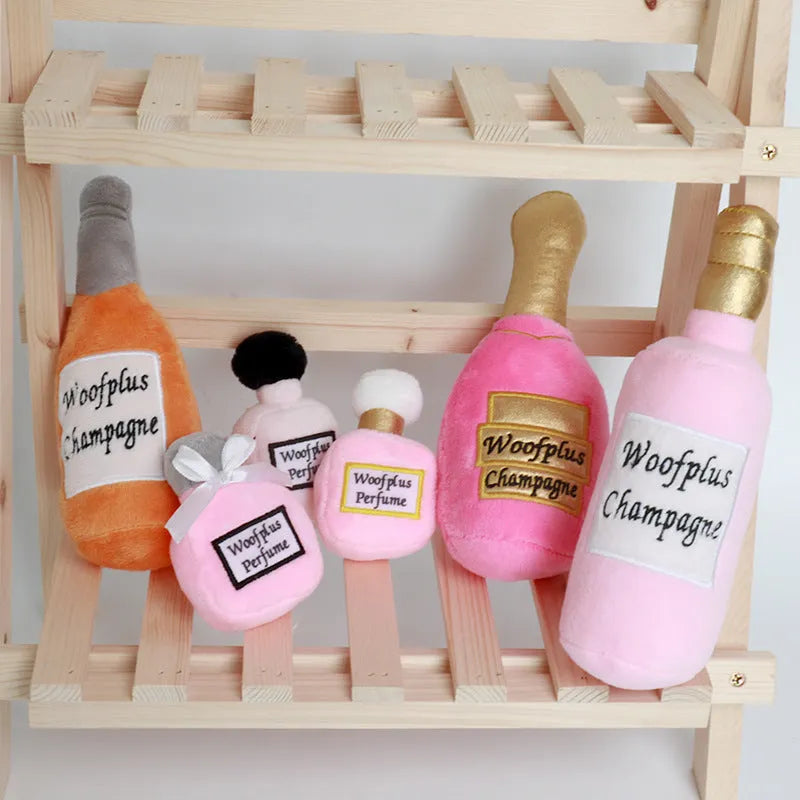 Soft plush pet toy shaped like a wine bottle in assorted colours including green, red, and black.