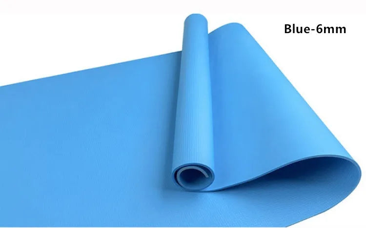 EVA foam yoga mat in blue, showing textured anti-slip surface, with a black OPP storage bag beside it.