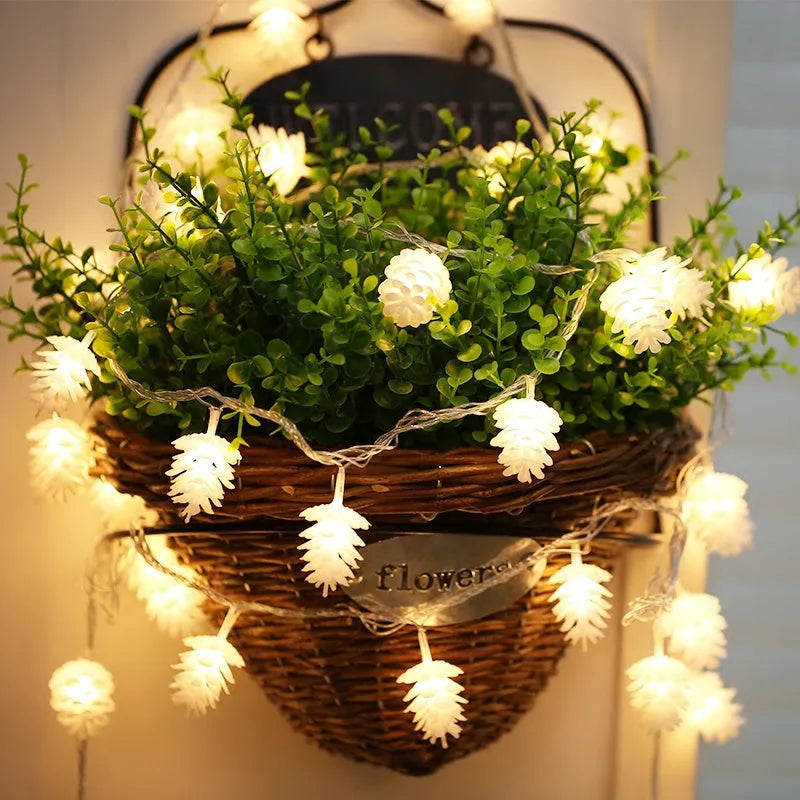 Warm white LED pine cone string lights with plastic shells in battery-powered decorative lighting