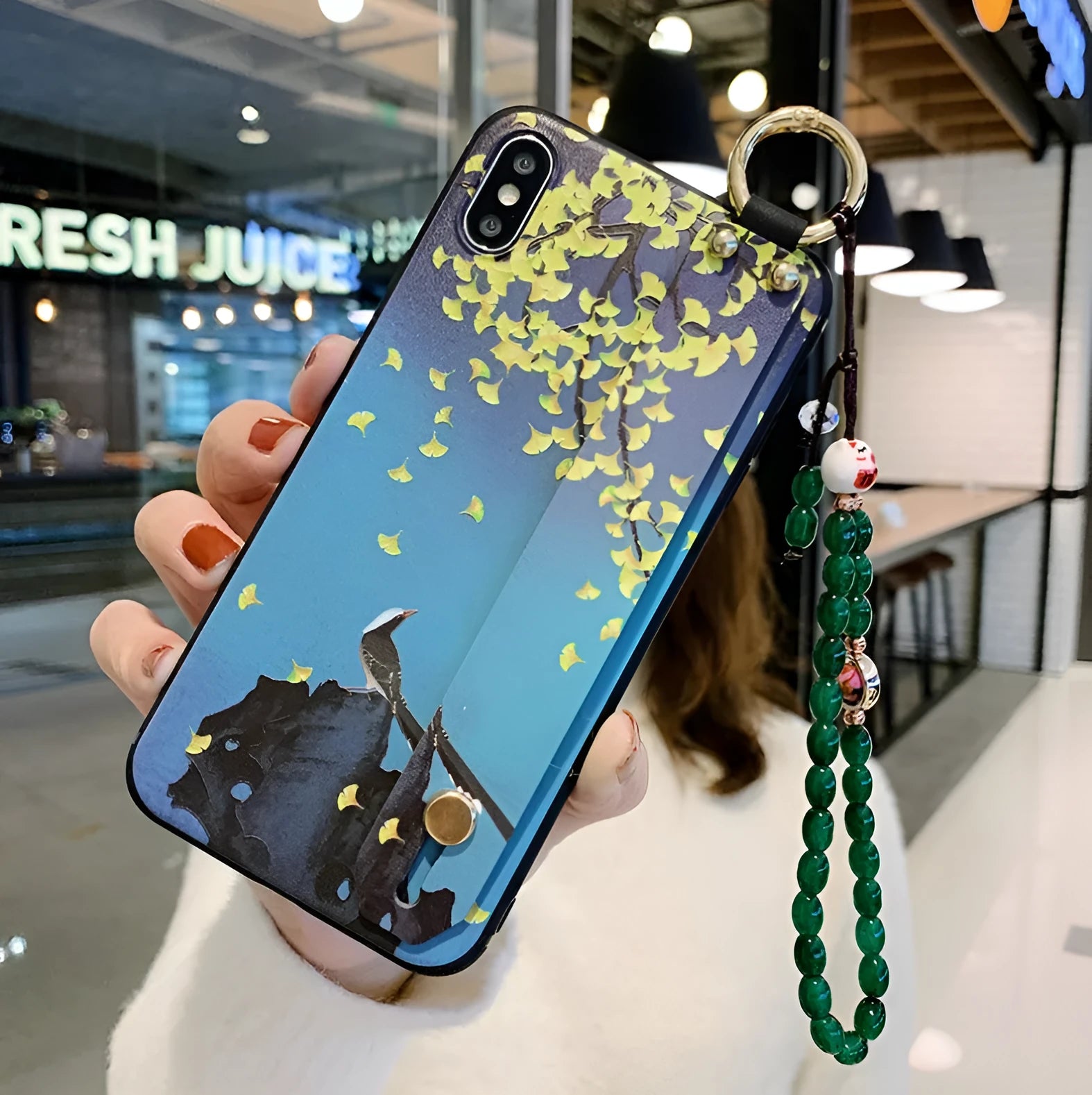 Rose floral patterned phone case for iPhone with a detachable wrist strap loop.