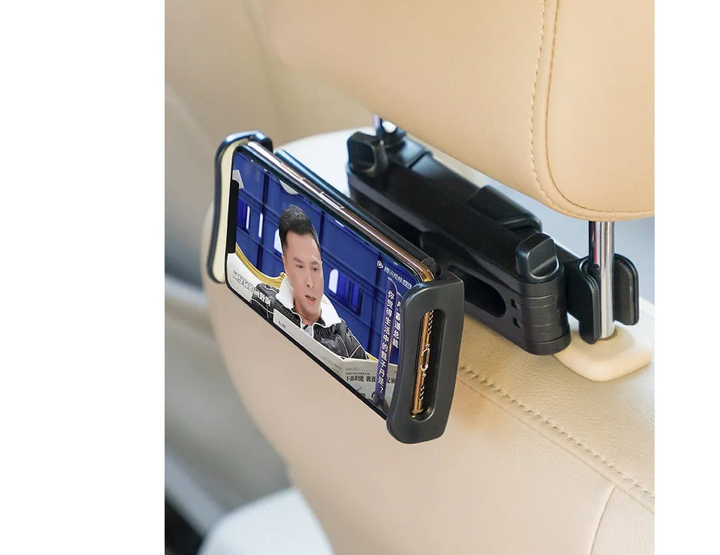 Black universal car phone holder mounted on vehicle rear seat with tablet in snap-in mechanism