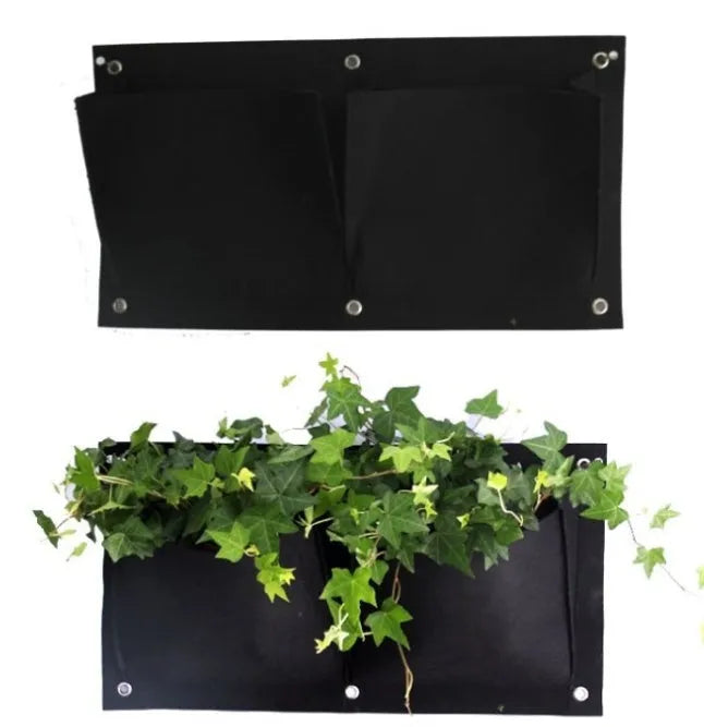 Green felt vertical wall garden planter bag with multiple planting pockets hung on a fence.