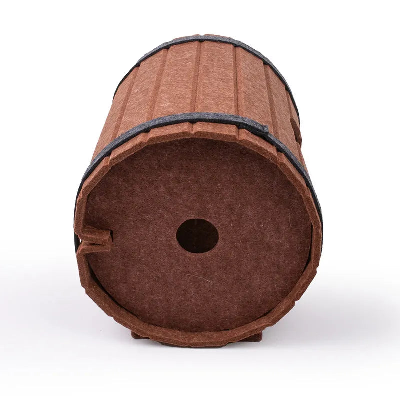 DIY assembled wine barrel shaped cat bed made from grey felt pieces with binding straps.