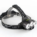 Fixed focus LED head torch with head strap, shown with its included charger.
