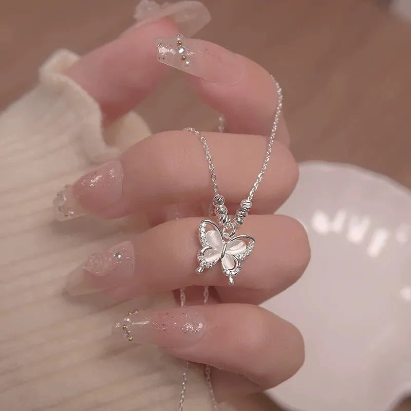 925 sterling silver opal butterfly pendant necklace on a silver adjustable cross chain.