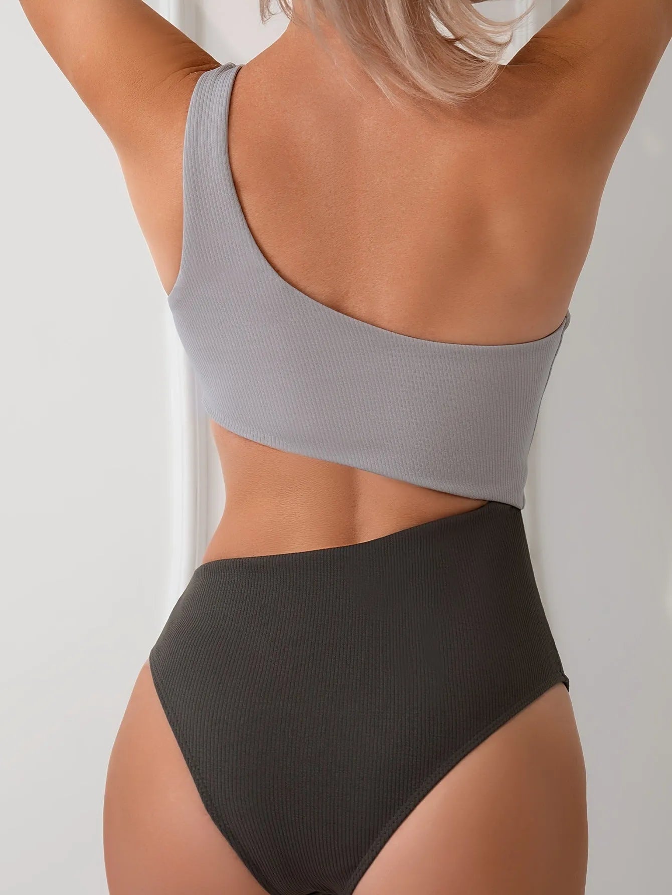 Women's light grey one-shoulder one-piece swimsuit on mannequin
