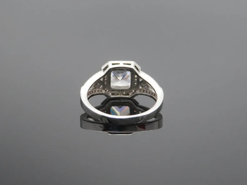 Women's geometric zircon ring with hollow design and quadrilateral shape in platinum colour.