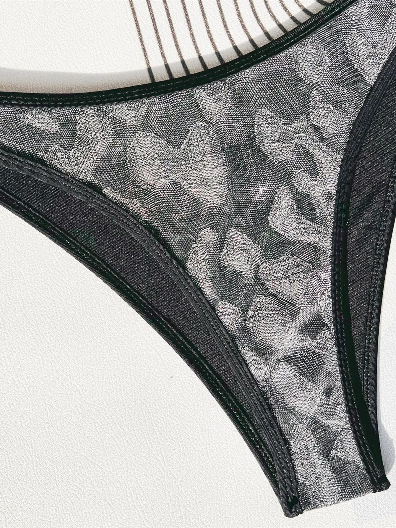 Black strappy women's bikini swimsuit made from polyester fabric.
