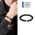 Mens black obsidian bracelet with silver prayer wheel charm on wrist