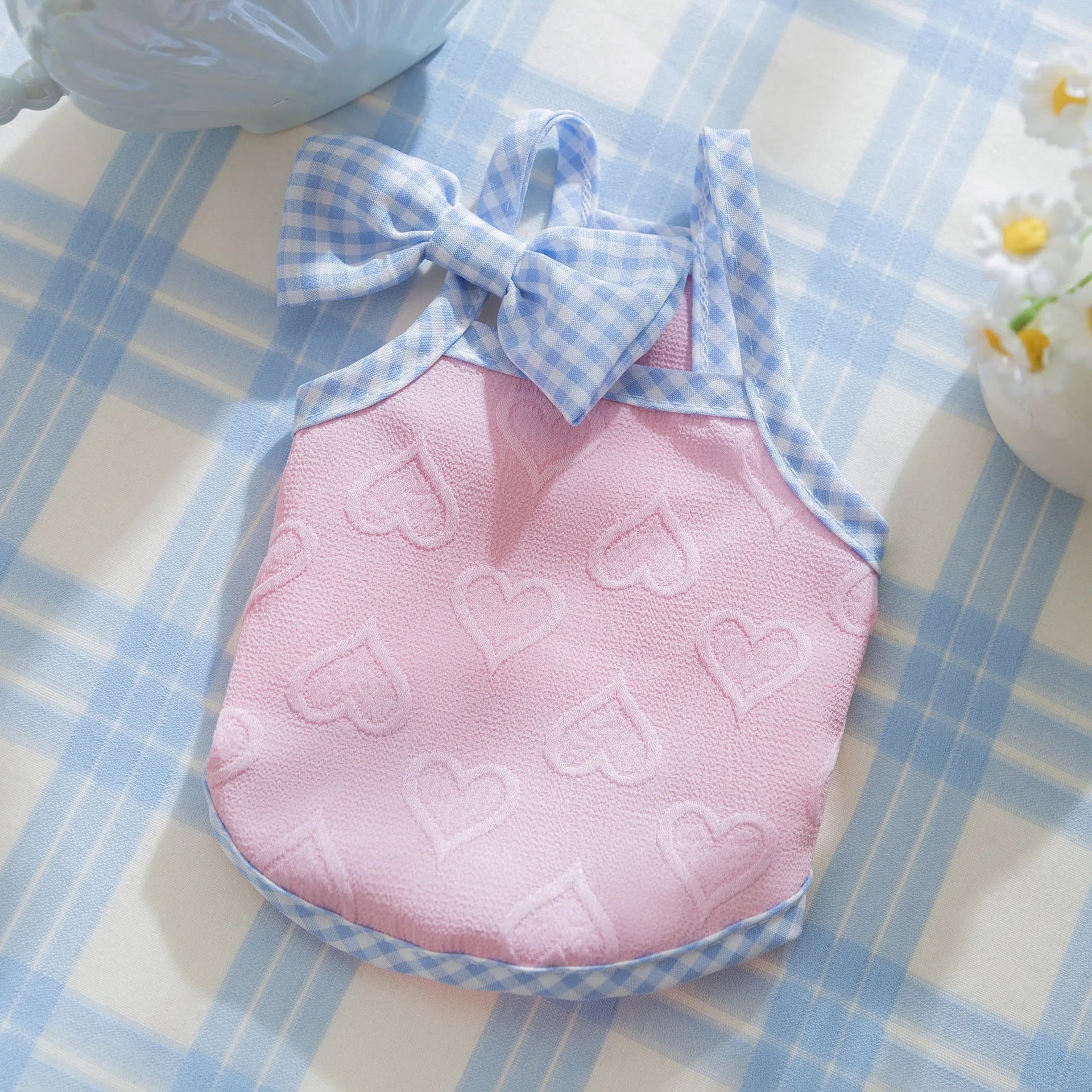 Small dog wearing heart texture vest with bow suspenders in Bondi Blue