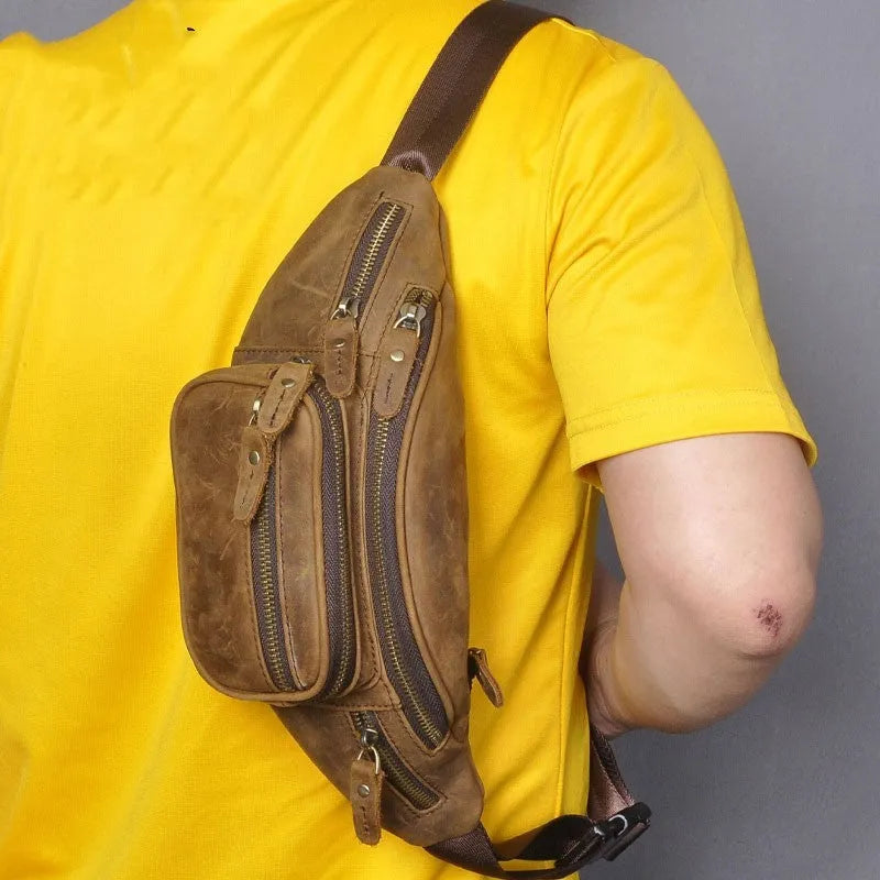 Retro brown leather messenger bag with a single shoulder strap shown open.