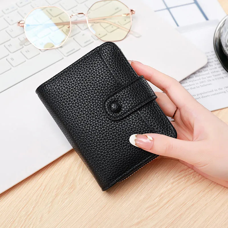 Beige ladies short wallet with a textured lychee pattern, shown in a two-fold open position.