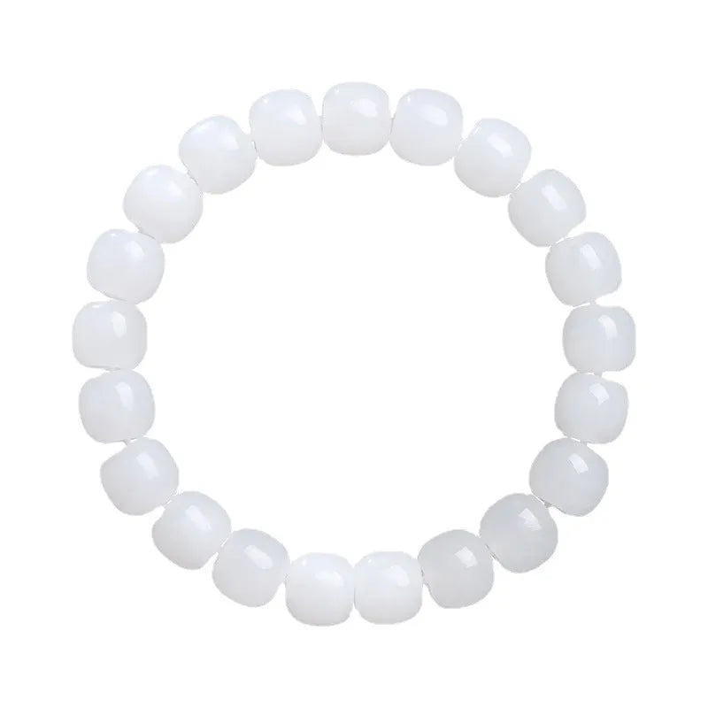 White jade barrel bead bracelet on wrist showing traditional Hetian jade material and barrel-shaped bead design