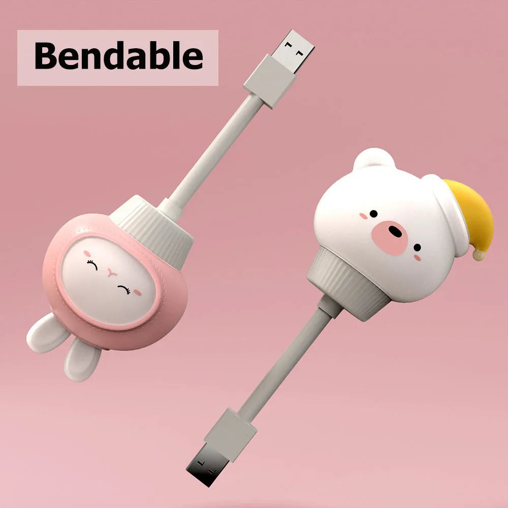 USB portable cartoon animal LED night light with remote control on a bedside table