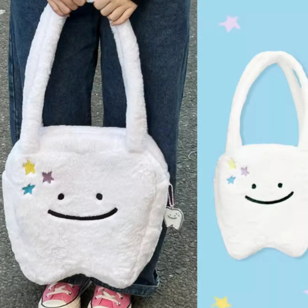 White plush tote bag with cute teeth pattern, showing crossbody strap and zipper closure.