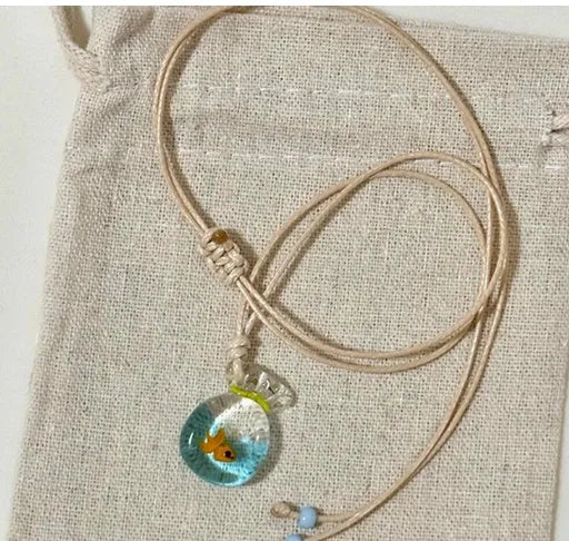 Women's skirt and joker charm pendant necklace with coloured glass on a cotton linen clavicle chain.