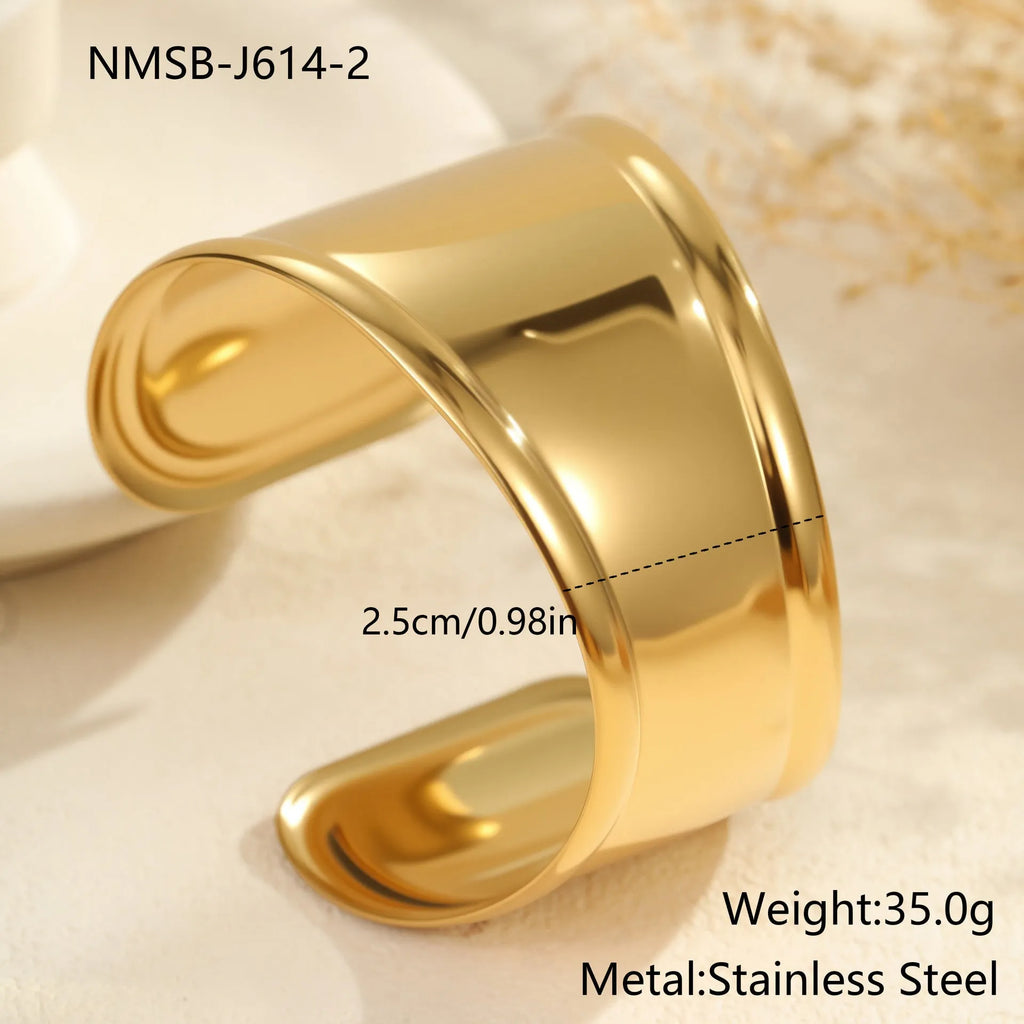 Women's wide stainless steel bracelet with geometric wave modelling and gold plating