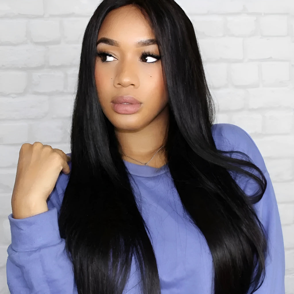 Long black straight synthetic wig with centre-parted bangs on a wig stand.