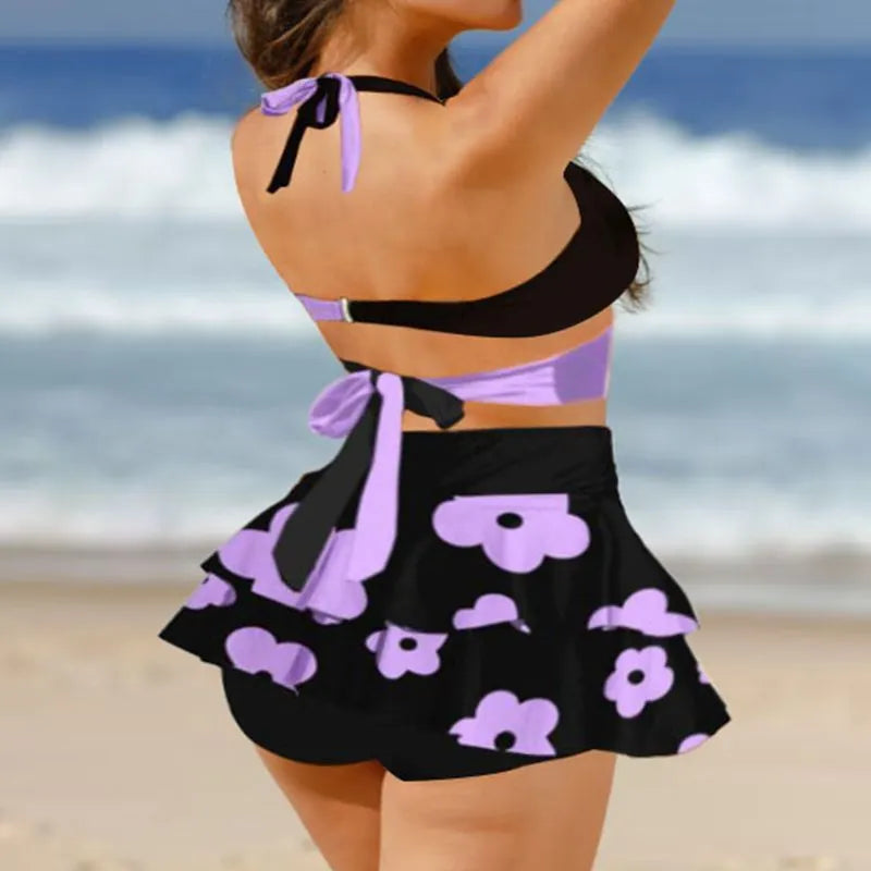 Purple women's bikini with lace-up detail and matching high-waisted split skirt