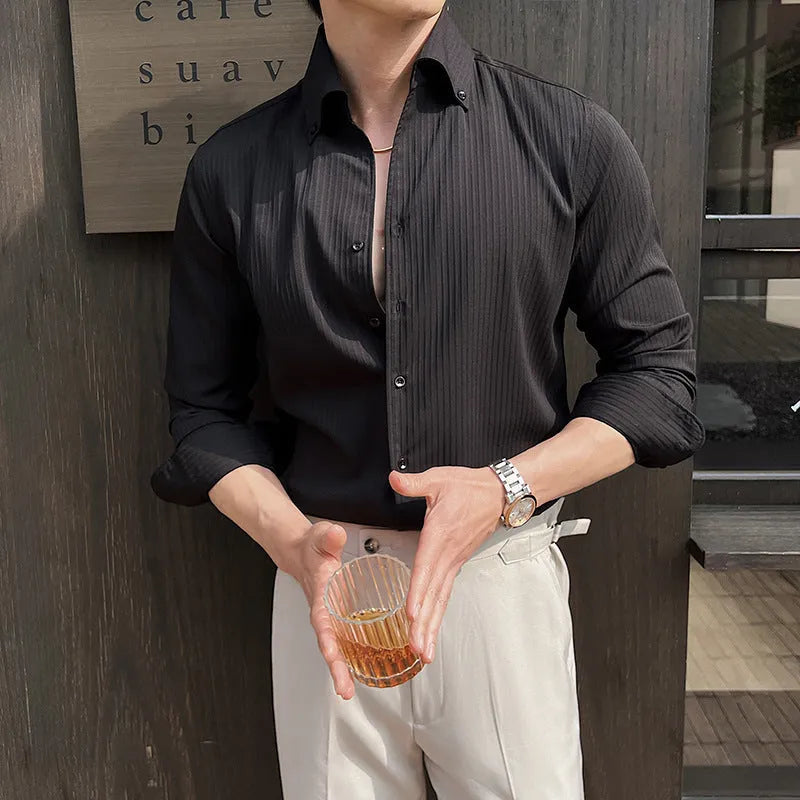 Man wearing a dark striped V-neck long sleeve casual shirt in a cardigan style.