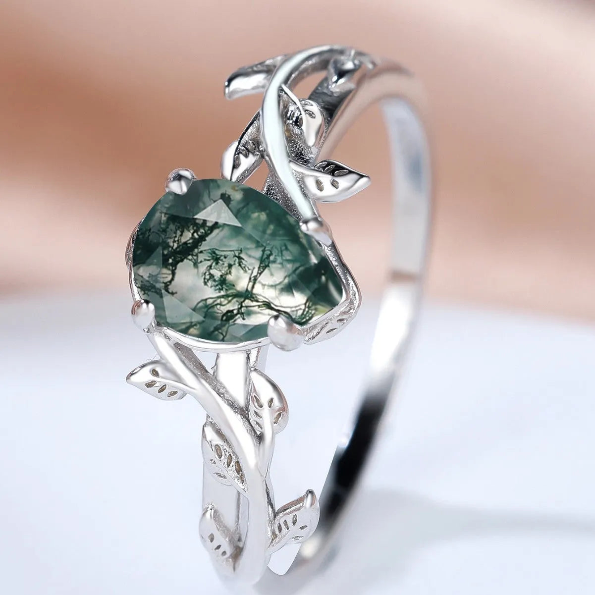 S925 silver drop-shaped agate edge branch leaf ring on white background, sterling silver band with natural stone