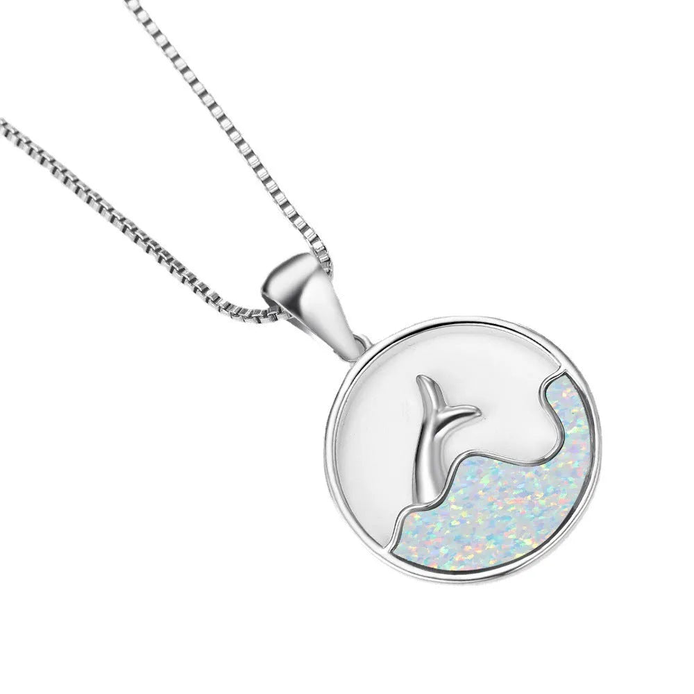White gold electroplated sea fishtail necklace with a round blue opal pendant on a chain.