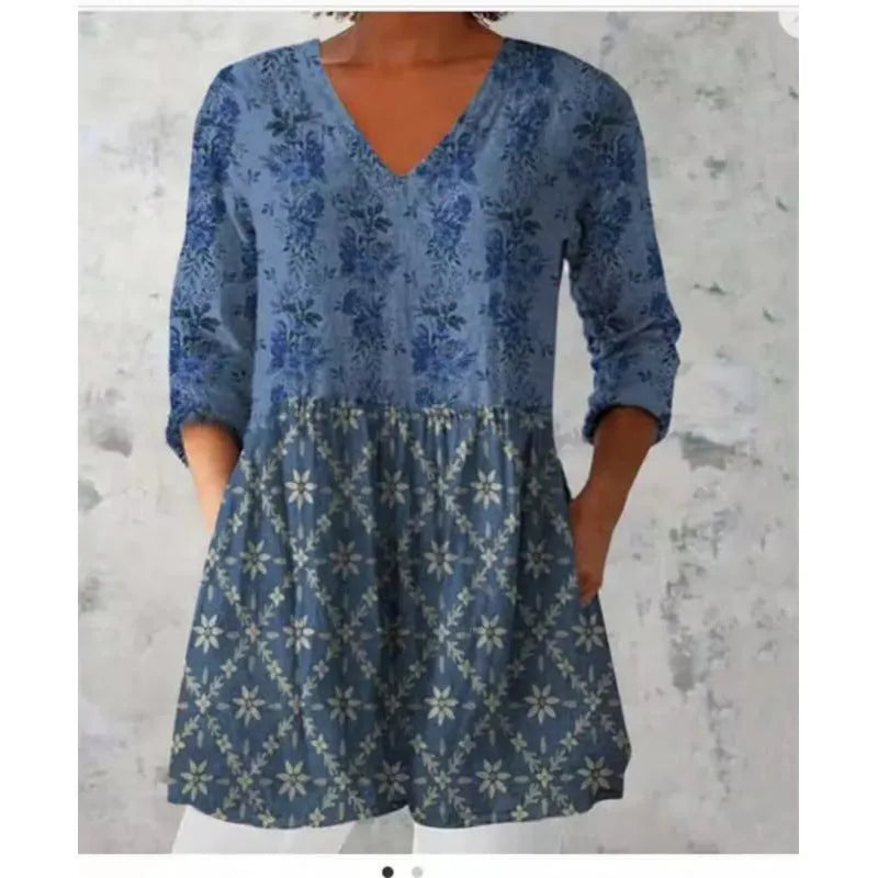 A woman wearing a loose, printed dress with 3/4 sleeves and a wide waist, available in multiple sizes.