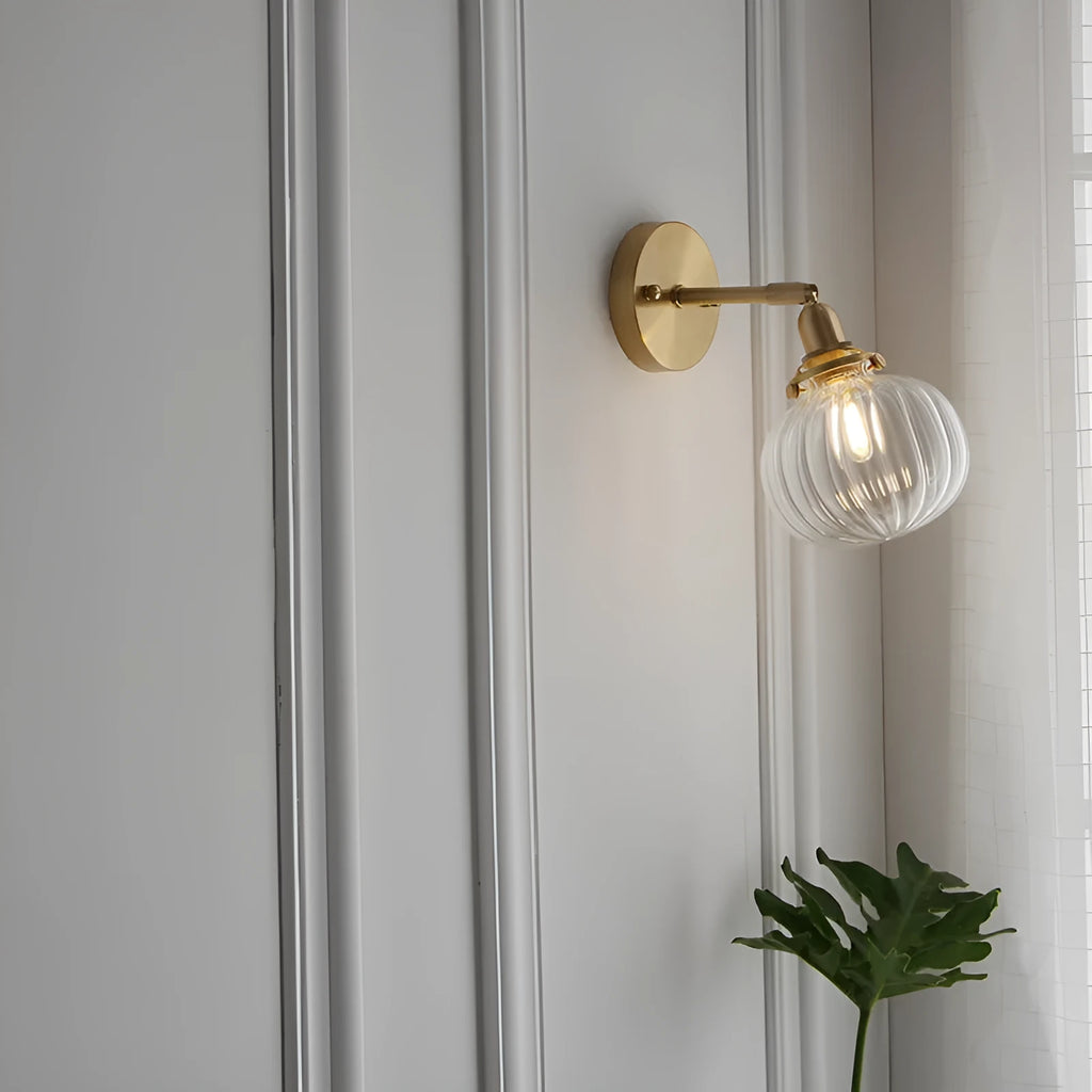 Pumpkin shaped transparent glass wall lamp with water ripple texture mounted on a wall