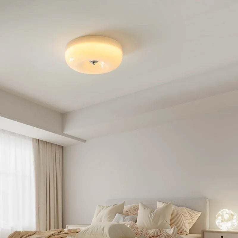 Cream coloured American style bedroom ceiling lamp with a modern vintage design shown in a bedroom setting.