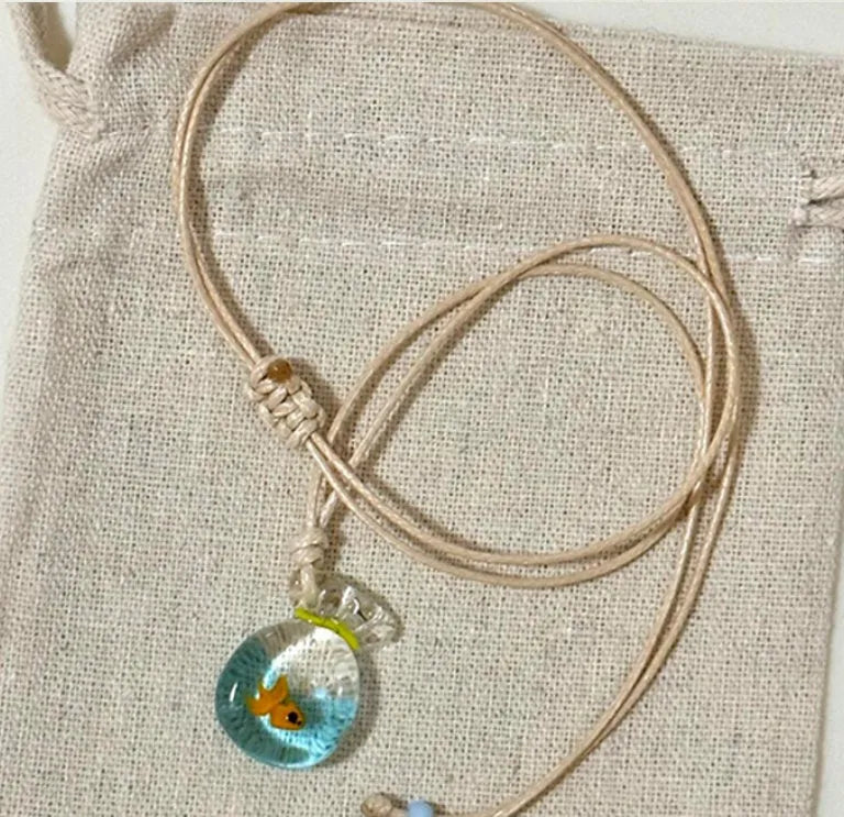 Women's skirt and joker charm pendant necklace with coloured glass on a cotton linen clavicle chain.