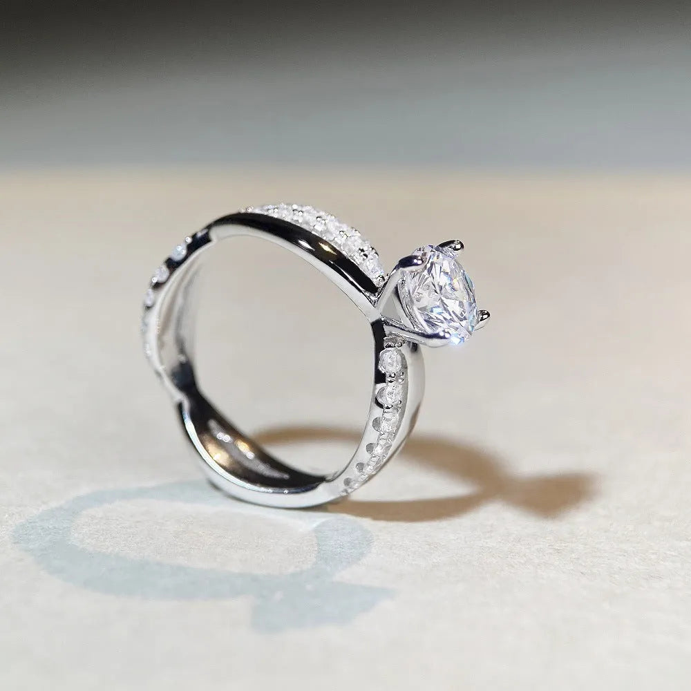 Geometric cross pattern silver ring with 1 karat moissanite stone in twisted arm setting