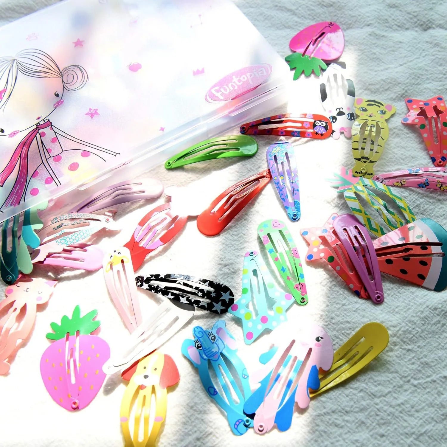 100 piece metal snap hair clip set showing animal, fruit, crown, star and flower designs in bright colours