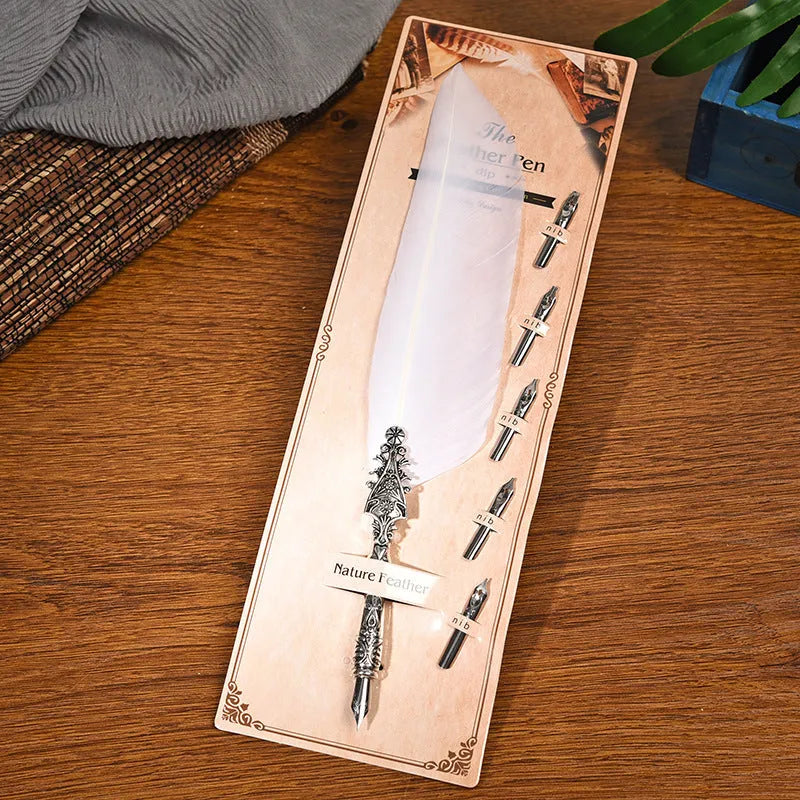 Vintage feather dip pen with zinc alloy body in ten colour options on cardboard packaging.