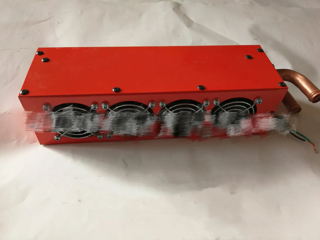 Metal car heater with four small copper pipes and two connection joints for 12V 24V vehicle heating.