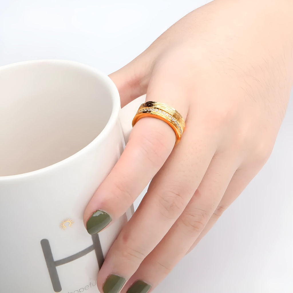 Gold geometric zircon ring in electroplated copper showing angular design details