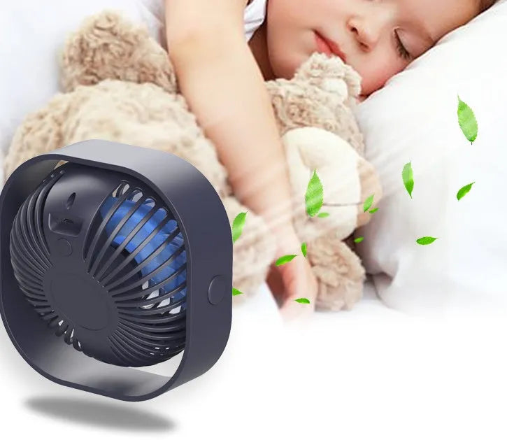 Compact USB desk fan in alarm clock style with blue colour finish, showing 360-degree rotation.
