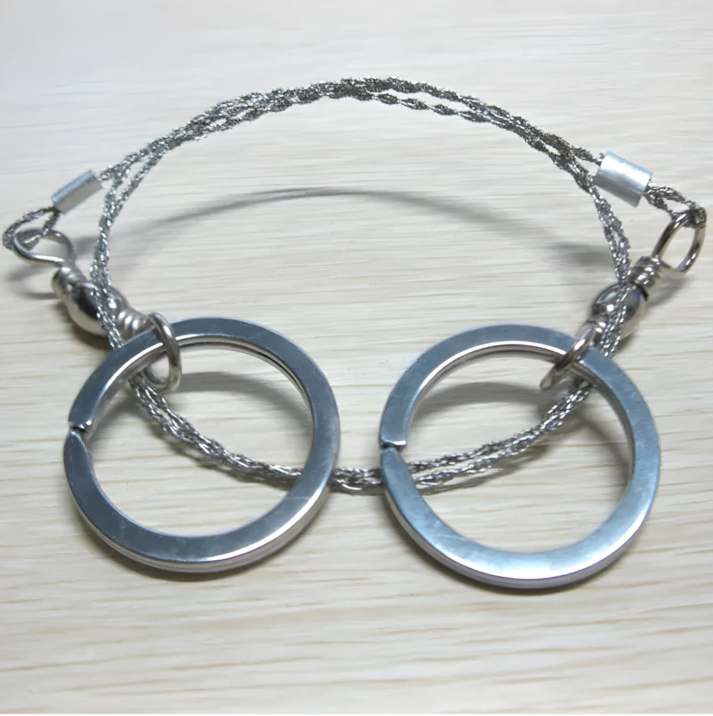 Stainless steel wire survival saw with thumb rings coiled for outdoor camping