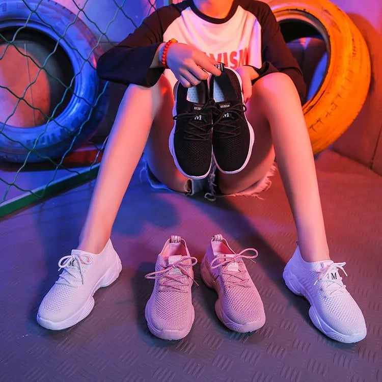 Women's white casual sports shoes with woven upper, thick rubber sole, and front strap fastening
